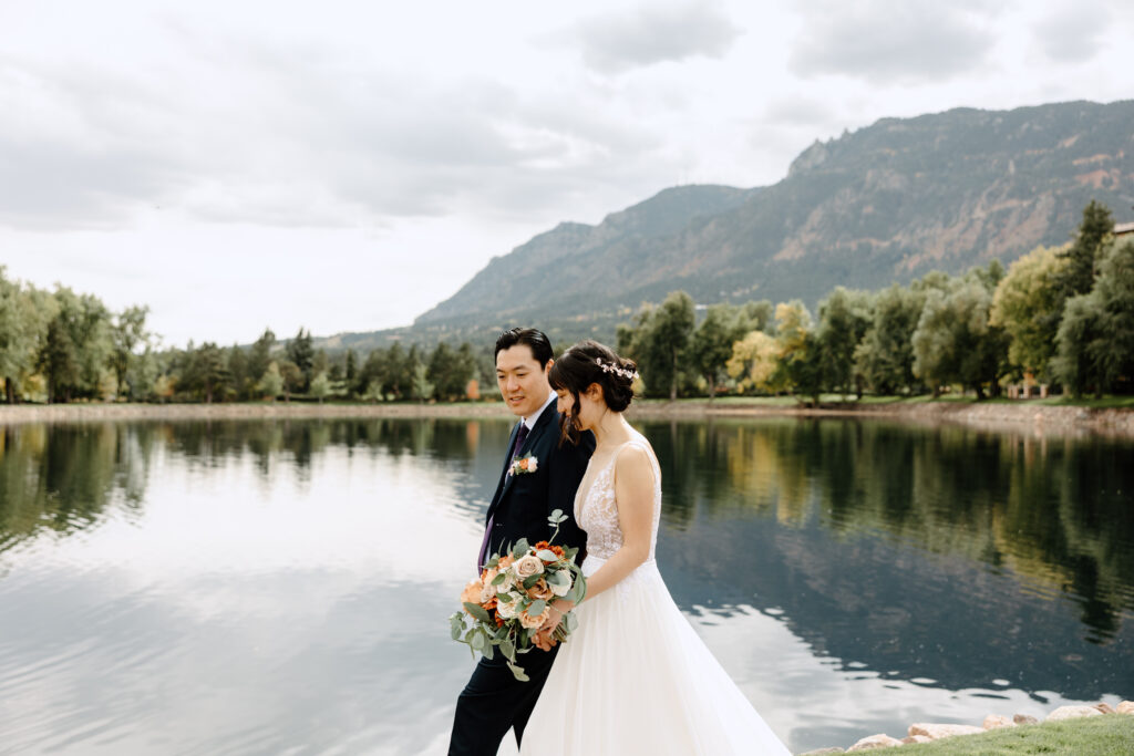 A Colorado Springs wedding couple walking the grounds of the Broadmoor with fall foliage