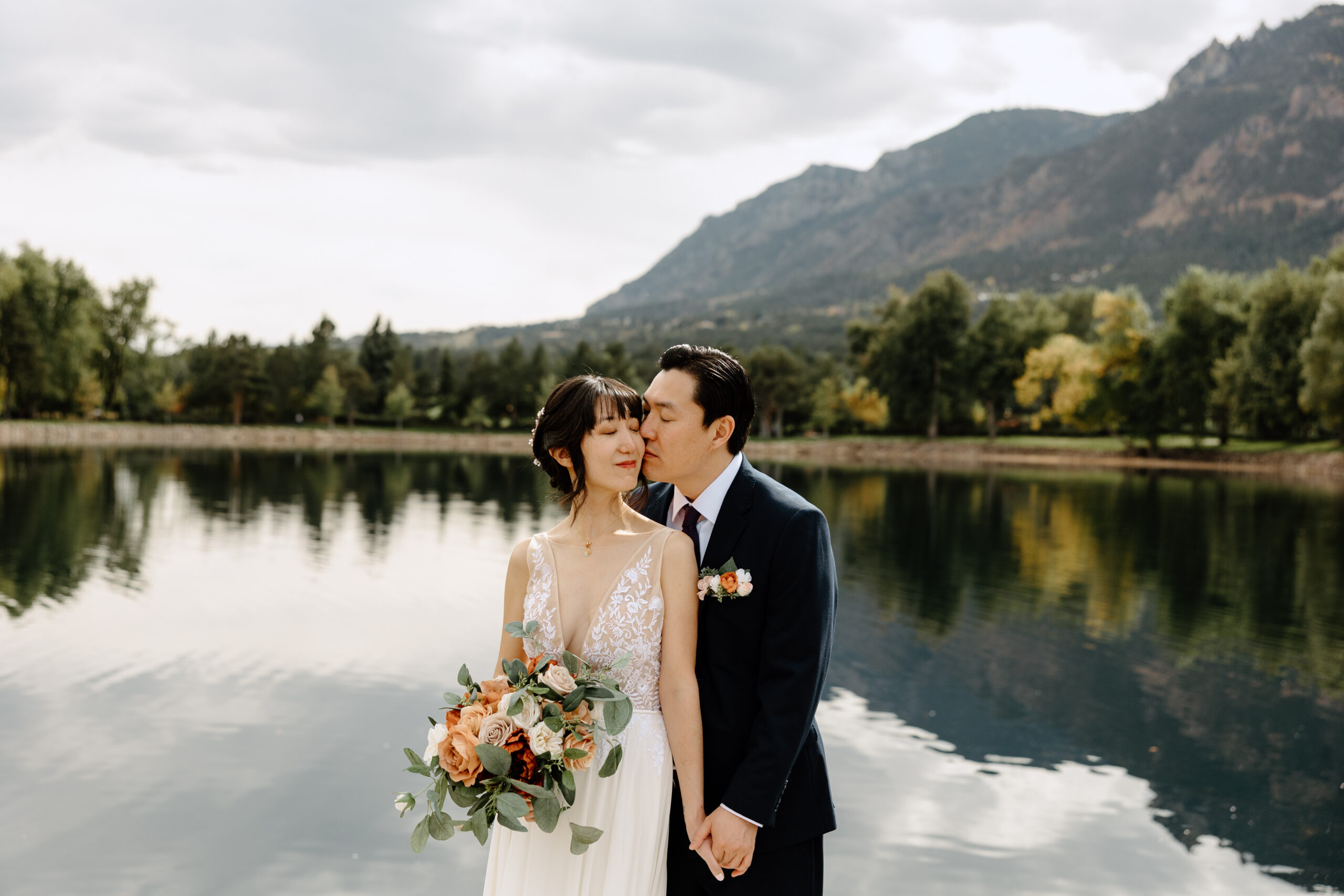 Bride and groom walking through The Broadmoor in Colorado Springs during fall