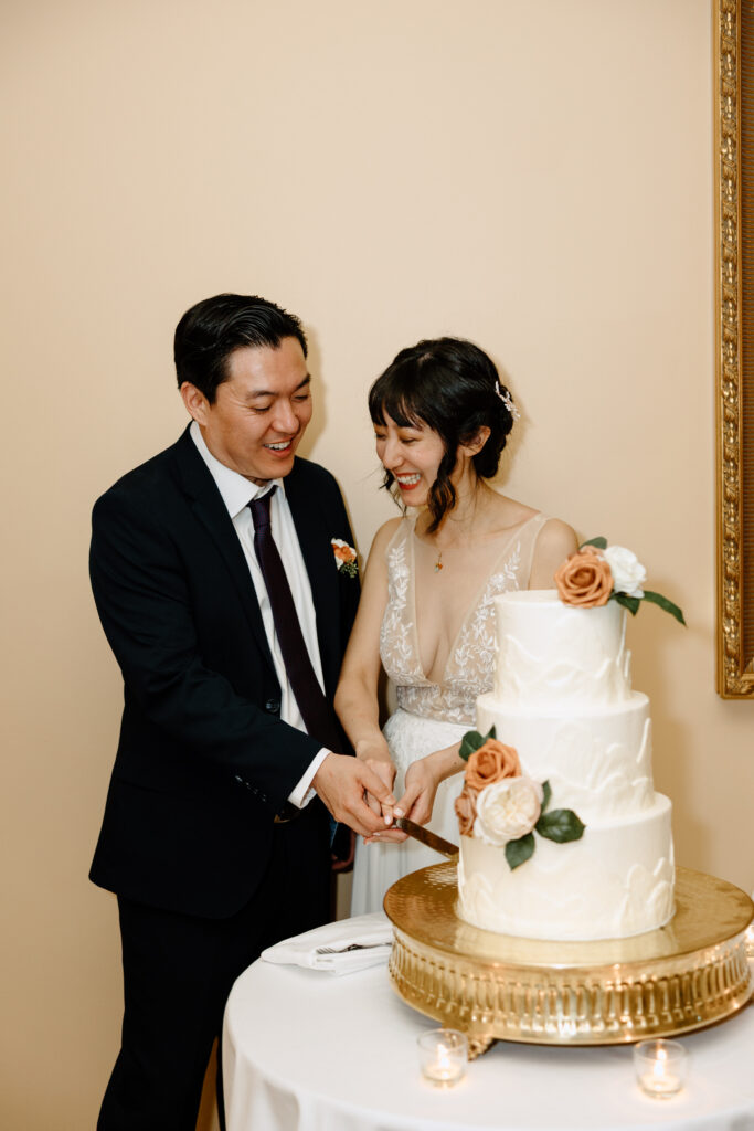 A happy couple cutting the cake at their Colorado wedding