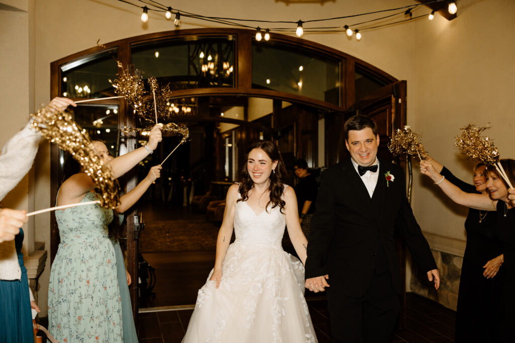 wedding send-off with pom poms and guests cheering