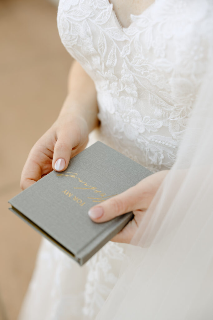 bride holding her vow book