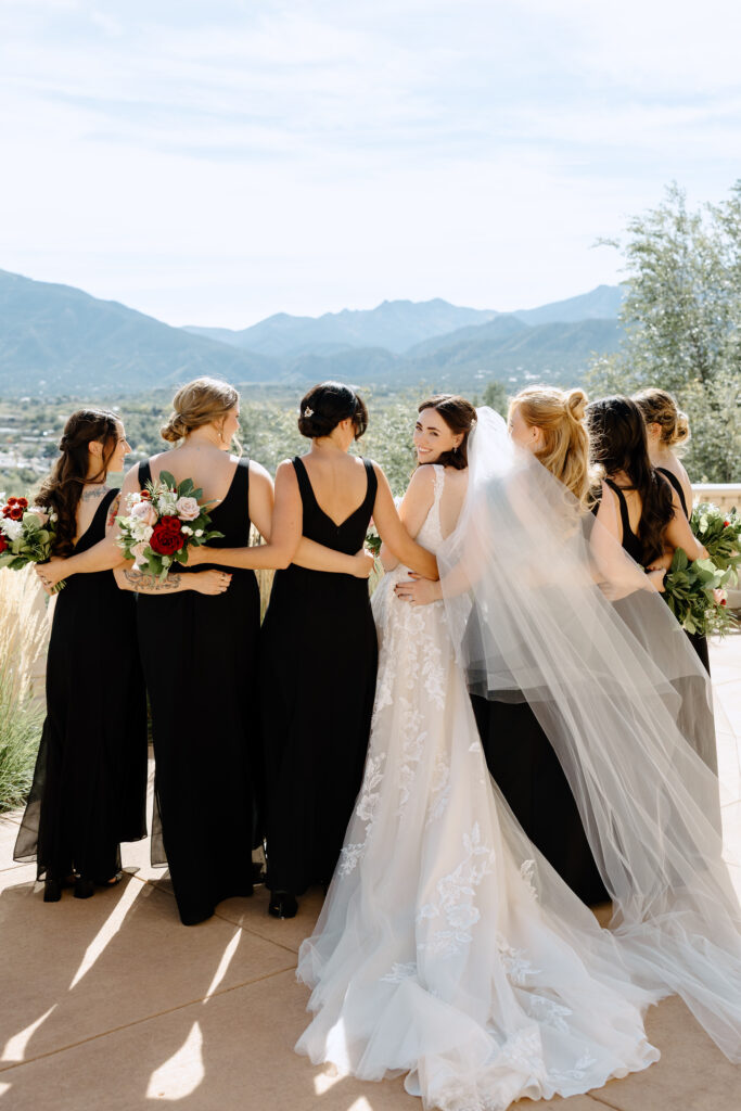 bridesmaids walking with the bride towards the mountains in Colorado Springs