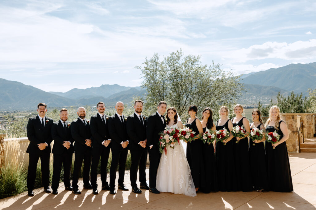 wedding party posing in front of Colorado Springs mountains