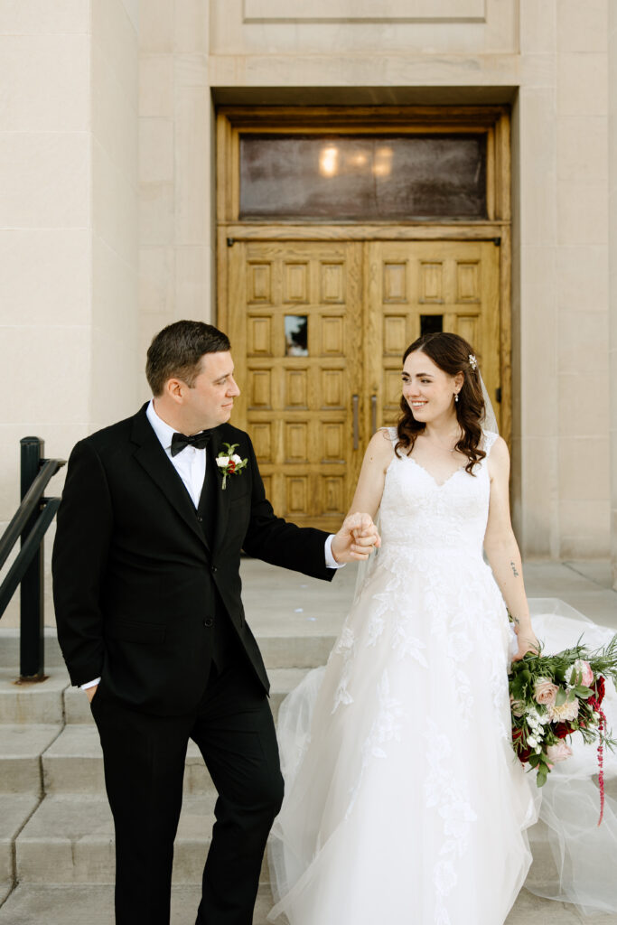 bride and groom walking down steps at Colorado Springs church